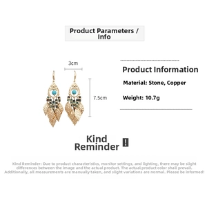 Détail de boucles d'oreilles bohèmes vintage avec perles turquoise et feuilles dorées