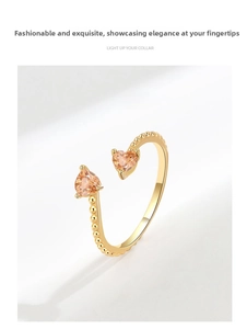 Detail of gold-plated open ring featuring two orange heart-shaped zircon stones