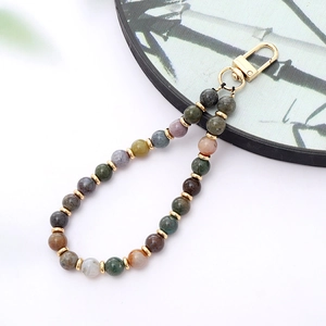 Detail of colorful stone beads phone strap with golden metal lobster clasp and spacers