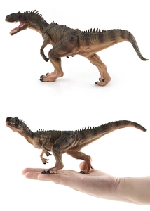 Detail macro of realistic dinosaur model skin texture and spikes held for size comparison