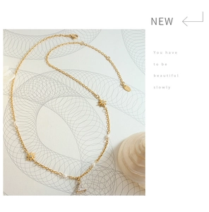 Detailed shot of S925 silver necklace with star charm, pearl, and triangle pendant