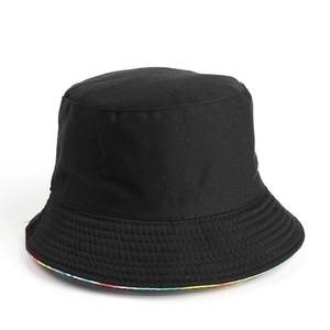 Detail of black bucket hat with vibrant rainbow tie-dye lining under the brim