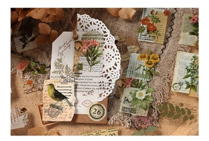 Retro PET stickers with vintage botanicals, birds, and newspaper snippets on linen background