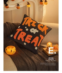 Detail of Halloween Trick or Treat embroidered pillow cover in a cozy festive setting