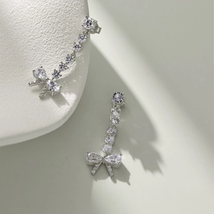 Detail view of long tassel bow earrings with S925 silver and sparkling cubic zirconia