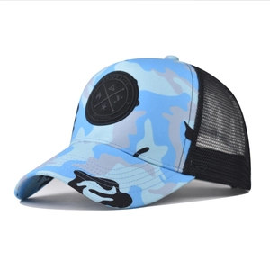 Detail showing camouflage trucker hat with breathable mesh and Enjoy Life rubber logo
