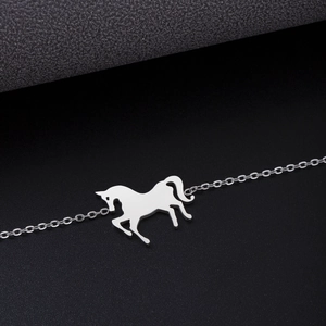 Detail of silver stainless steel horse pendant necklace with fine cable chain texture