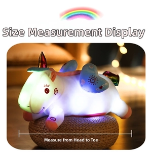 Close-up detail showing the size measurement method for the glowing plush unicorn toy