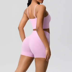 Side view of pink yoga set with spaghetti straps crop top and high waist sports shorts