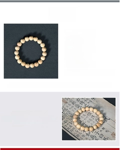 Macro detail of 10mm creamy wood prayer beads with natural grain and smooth finish