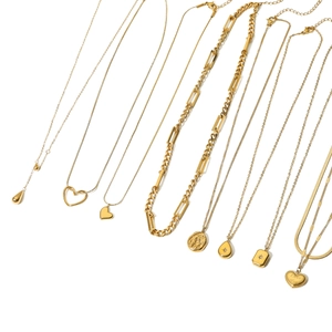 Minimalist gold necklaces collection featuring heart and teardrop pendants on white backdrop