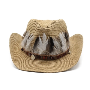 Detail of western straw hat featuring ethnic feather band and silver metal pendants