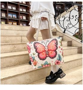 Detail of canvas tote bag with pink butterfly print and sturdy rope handles