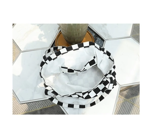 Macro shot of checkered tote bag interior featuring a white lining and zip pocket