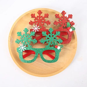 Detail of red and green glitter snowflake glasses on a wooden tray for Christmas parties