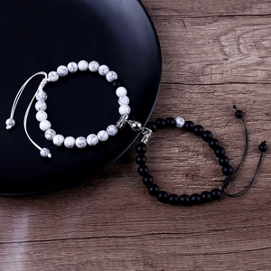Macro detail of natural stone couple bracelets with 8mm beads and magnetic heart clasp