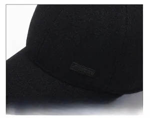 Detail showing the thick black wool fabric and SPORT patch of the winter baseball cap