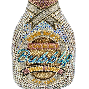 Macro shot of luxury champagne bottle clutch bag with colorful rhinestones and Sweet Bubbly text