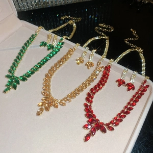 Macro view of gold jewelry sets with zircon wheat tassel earrings and necklaces