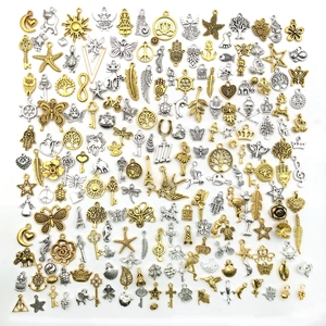 Macro detail of assorted gold and silver DIY alloy charms with intricate vintage patterns