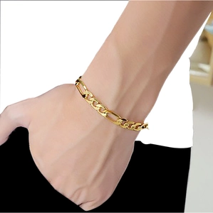Classic 18K gold plated stainless steel Figaro link chain bracelet worn on a male wrist