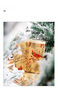 Detail of kraft Christmas gift wrap with northern cardinal, pine branches, and jute twine