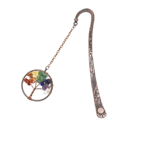 Detail of vintage bronze bookmark featuring moon engraving and tree of life stone pendant