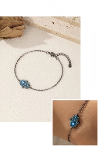 Detail of S925 sterling silver Hamsa Hand bracelet with blue evil eye beads and adjustable chain