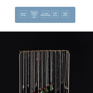 Close-up of golden iron jewelry rack with solid wood base for necklace display