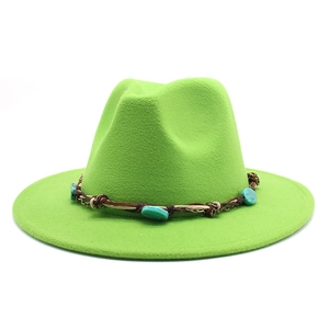 Detail of green wool fedora hat featuring bohemian turquoise stone decorative band
