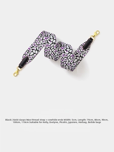 Close-up of 5cm leopard print webbing strap with gold buckles and leather connectors
