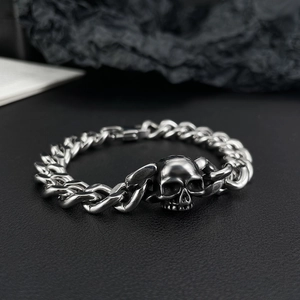 Polished stainless steel Cuban link bracelet for men with a 3D skull charm on black leather