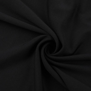 Macro shot of the black knitted stretch fabric with fine mesh texture and soft draping folds