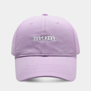 Close-up of lavender cotton baseball cap featuring white 'mom' embroidery and textured fabric