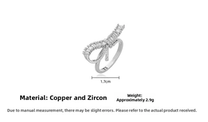 Detailed view of silver bow ring with cubic zirconia stones measuring 1.7cm in width