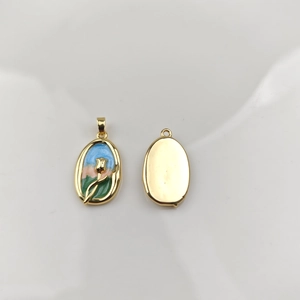 Detailed macro view of oval enamel tulip flower pendants with gold plated metal finish