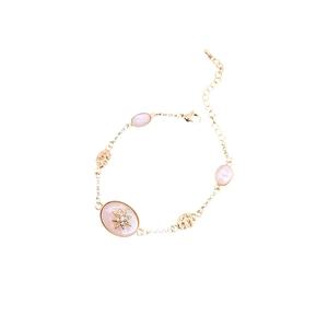 Gold starburst bracelet with oval pink stones and sparkling zircon details for women