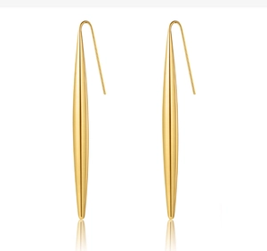 Detailed view of long gold spindle-shaped drop earrings with a polished finish