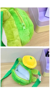 Close-up of green plush turtle bag showing the high-quality zipper and white inner lining