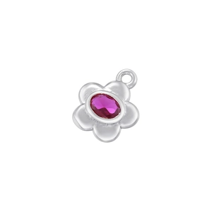 Macro shot of silver flower pendant with rose red oval gemstone and polished finish