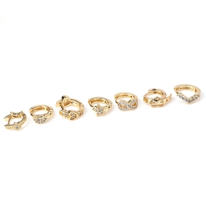 Set of 7 gold asymmetric cartilage hoop earrings with star moon and heart motifs