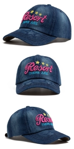 Detail view of Resort embroidery and yellow stars on navy denim washed baseball cap