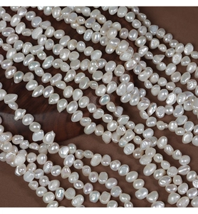 Macro detail of white baroque freshwater pearls with high luster for DIY jewelry making