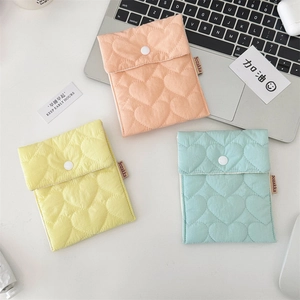 Quilted cotton sanitary napkin pouches in pink, yellow, and green with heart pattern