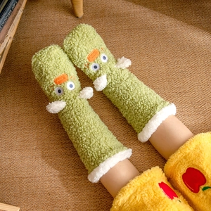 Cosy green plush floor socks with cute cartoon duck design on warm woven carpet