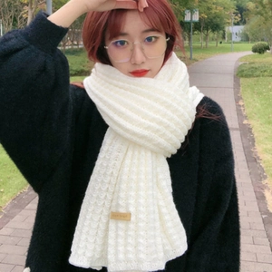 Winter chunky knit white scarf for women in a soft warm style with a small beige tag