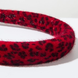 Close-up of red and black leopard print headband with soft faux fur texture detail