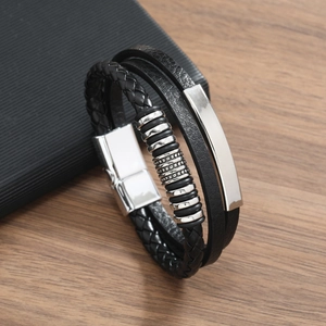 Detail of multi-layer black braided PU leather bracelet with silver magnetic metal clasp