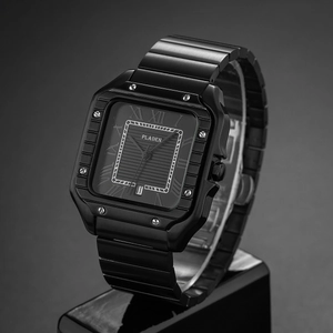 Detailed view of square black watch dial with Roman numerals and metal link strap