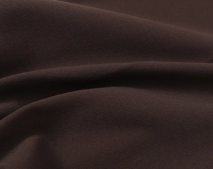 Detail of premium chocolate brown fabric showing fine texture and soft drape quality